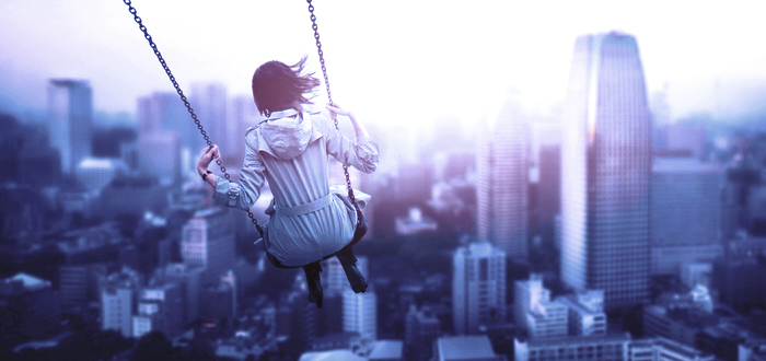 Woman on swing with view of skyscapers